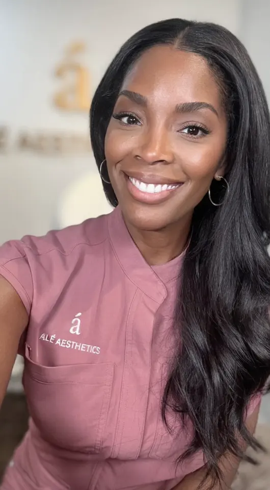 Ale Aesthetics team member in branded scrubs