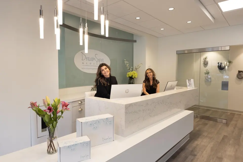 Front desk staff at the reception counter of the Brookline office