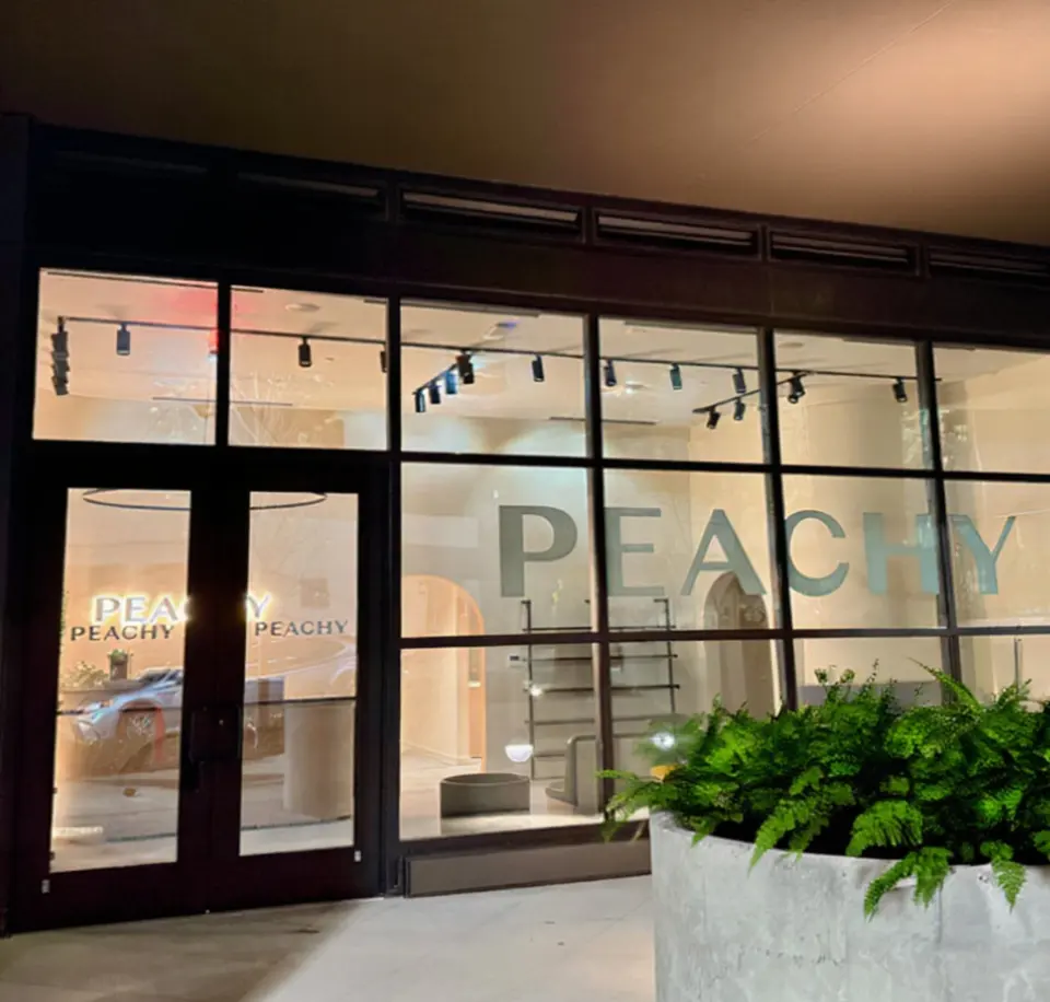 Storefront exterior of Peachy Studio Atlanta Midtown at night
