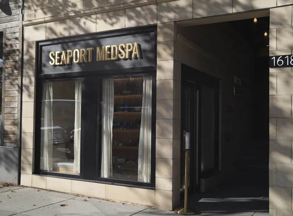 Close-up of the Seaport Medspa Brookline storefront entrance showing the '1618' address plaque
