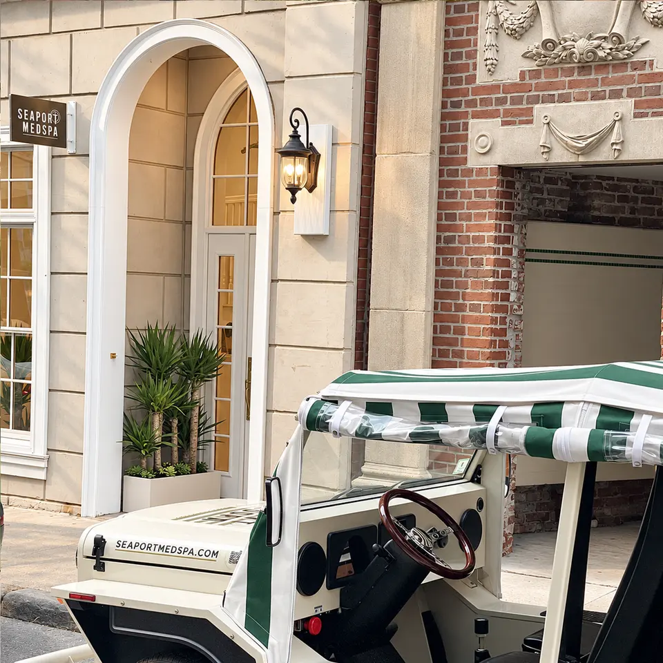 Seaport Medspa North End storefront entrance with branded golf cart parked outside