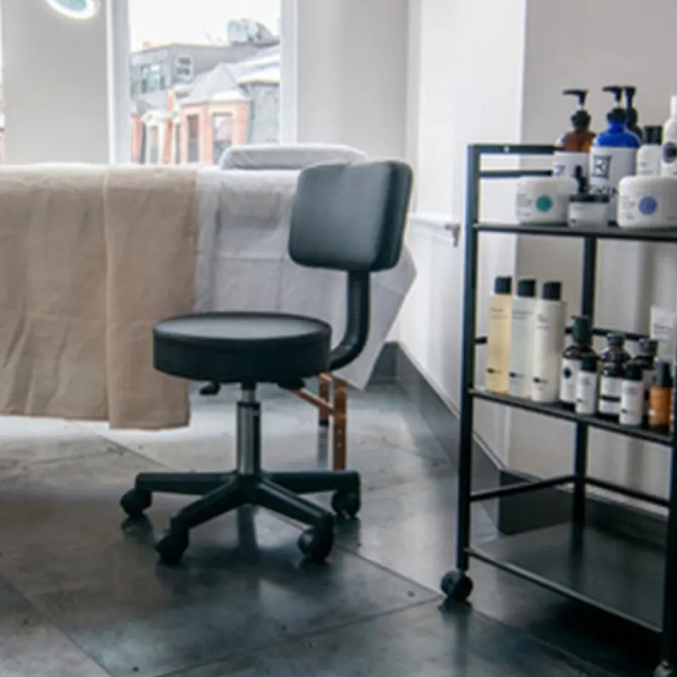 Treatment room interior at Skin Spa New York Back Bay with treatment bed and product cart