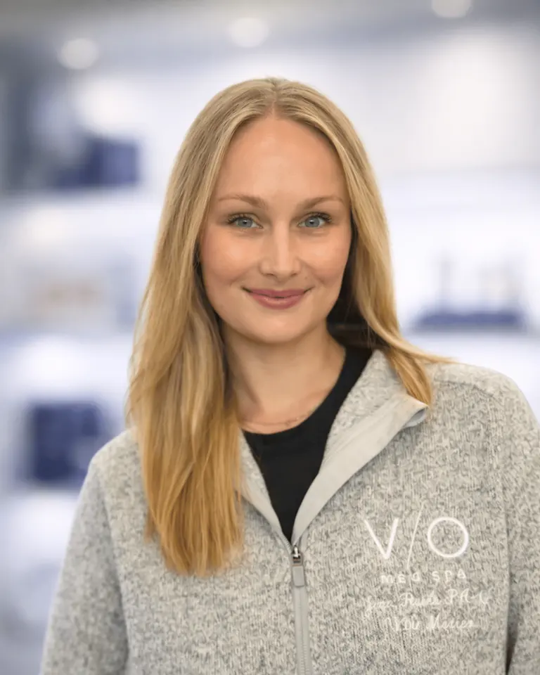 Jenn Rulka, PA, Injector at VIO Med Spa Newton, photographed in the clinic retail/display area