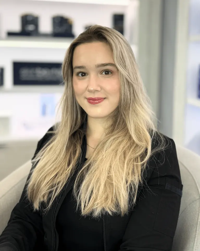 Camila Gulin, NP, Injector at VIO Med Spa Newton, photographed in the clinic retail/display area