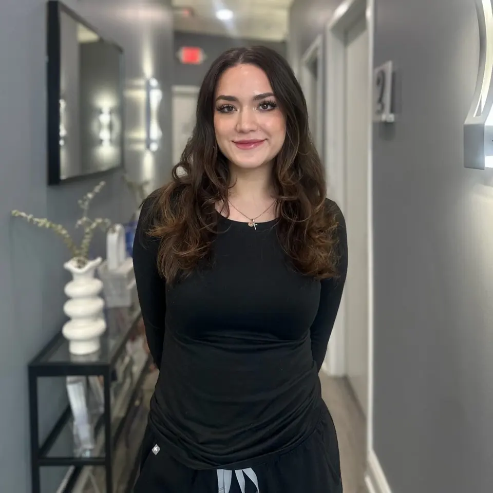 Brianna Perez Perette, Aesthetician, in the VIO Med Spa South End hallway